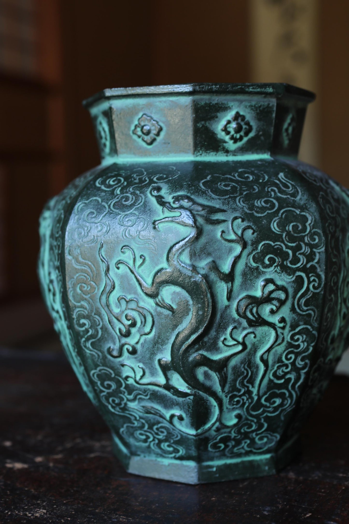 A close-up image of a decorative vase with an intricate dragon design on its surface.