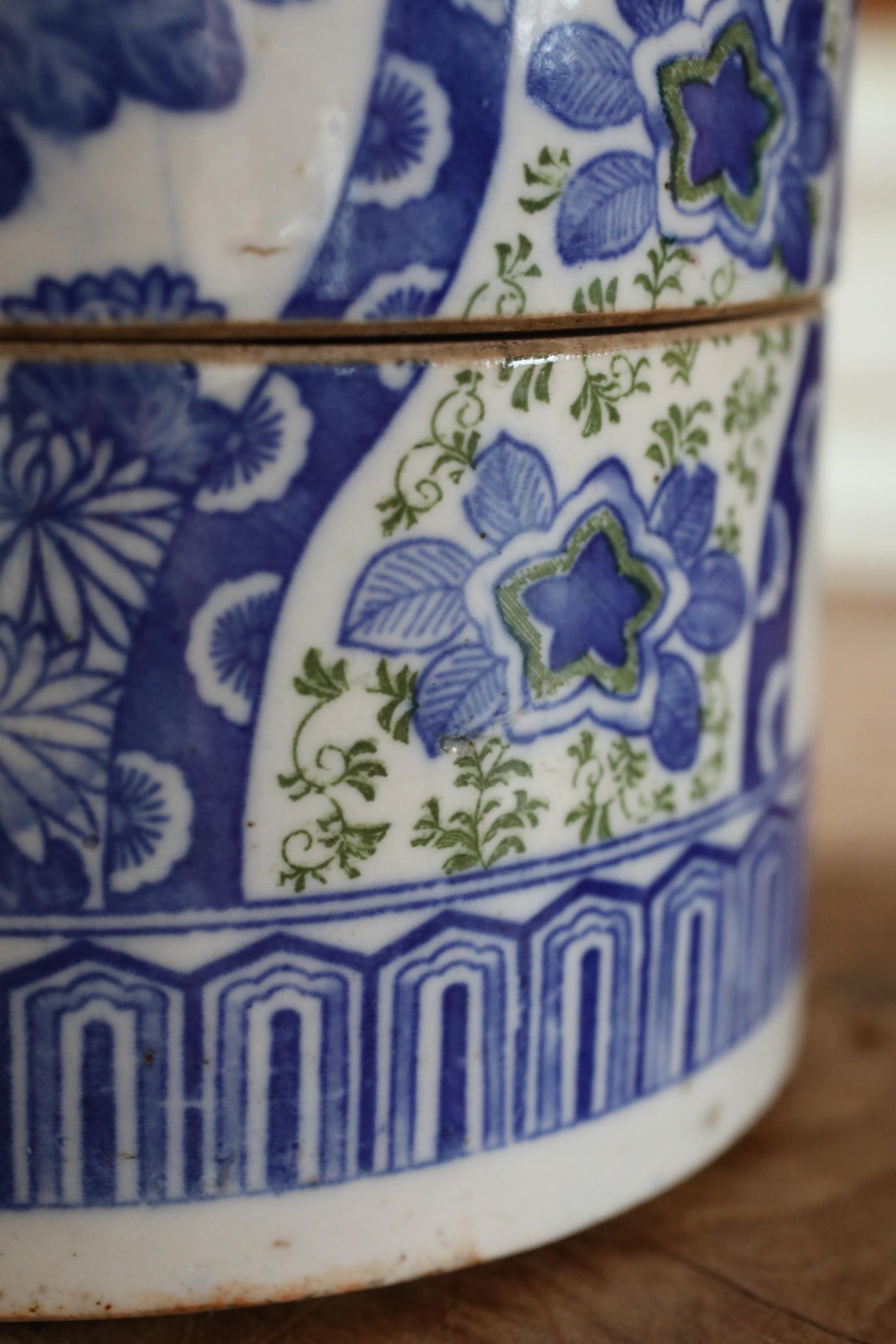 A close-up view of a decorative ceramic vase with a blue and white floral pattern.