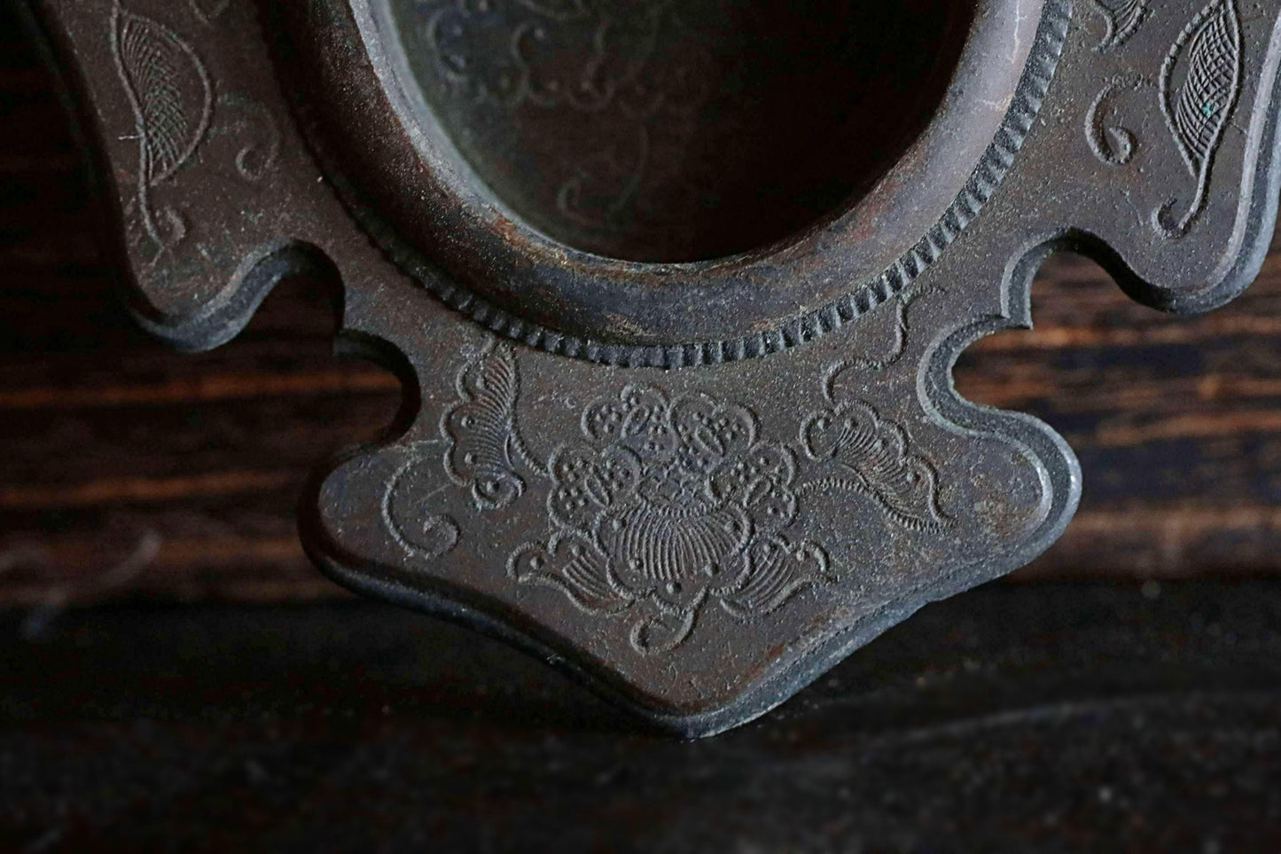 a close-up view of an ornate, antique-looking metal object with intricate floral designs.