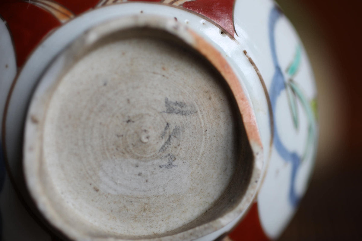A close-up view of a ceramic bowl or dish with a white and red patterned design.