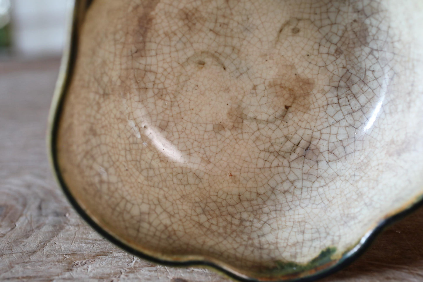 A close-up view of a ceramic bowl with a textured, cracked surface.
