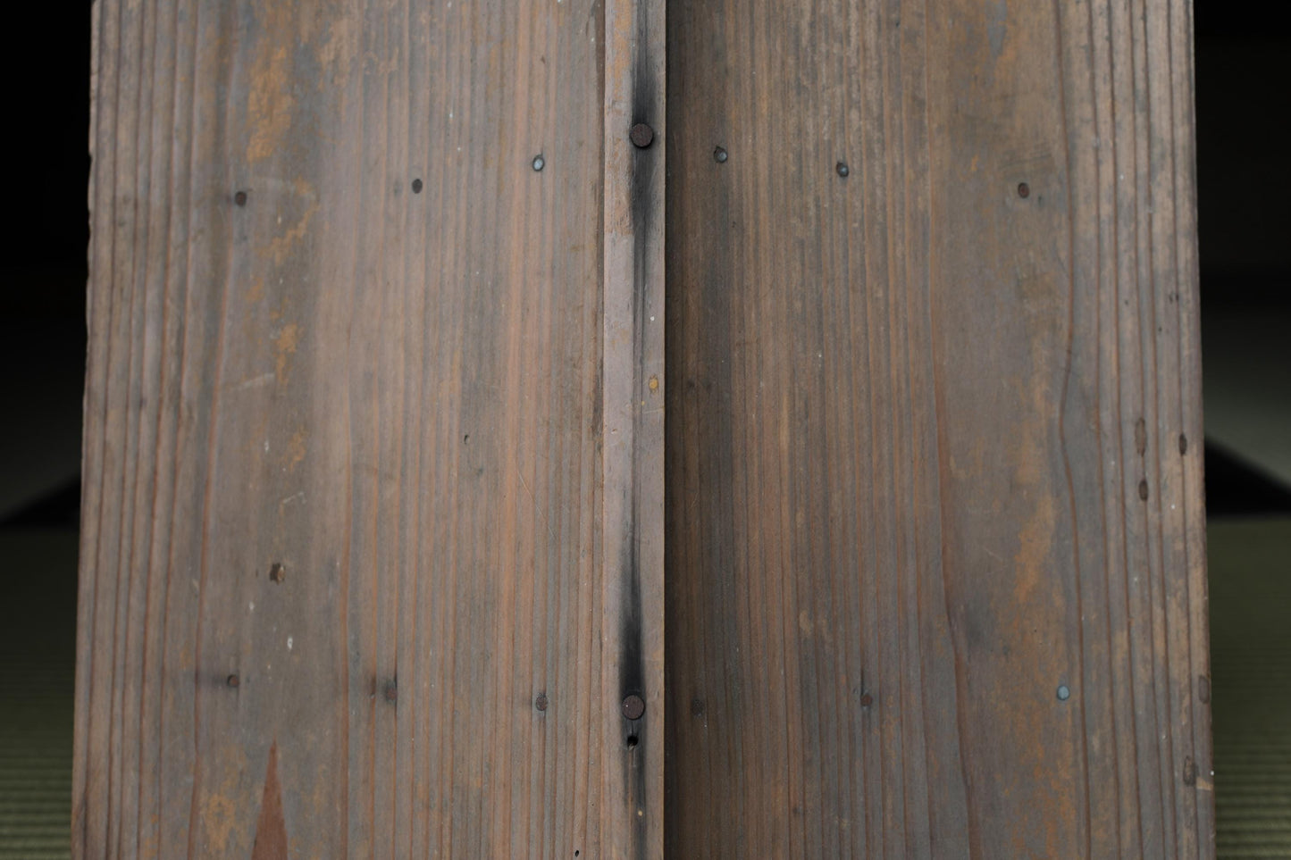 a close-up view of a wooden door, with visible grain and texture.