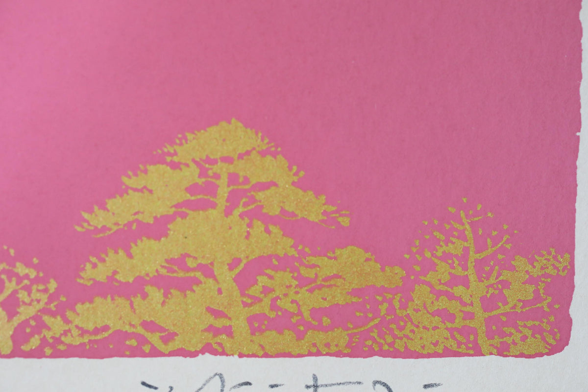 a close-up view of a pink background with a golden tree design.