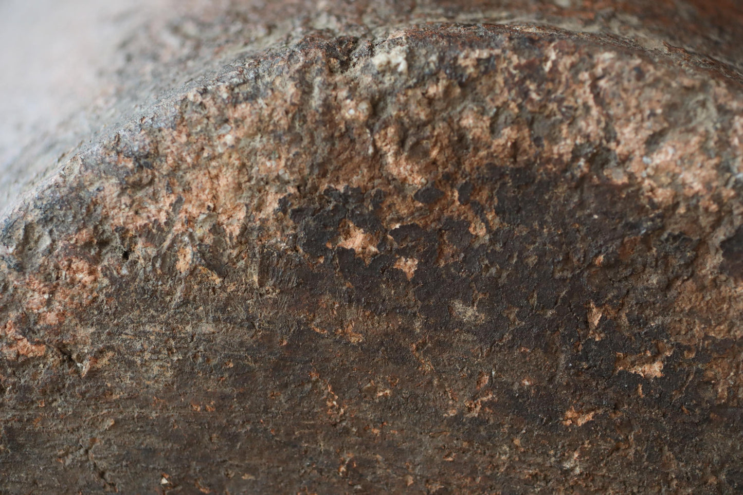 a close-up view of a rusted metal surface, with visible signs of wear and tear, such as rust and peeling paint.