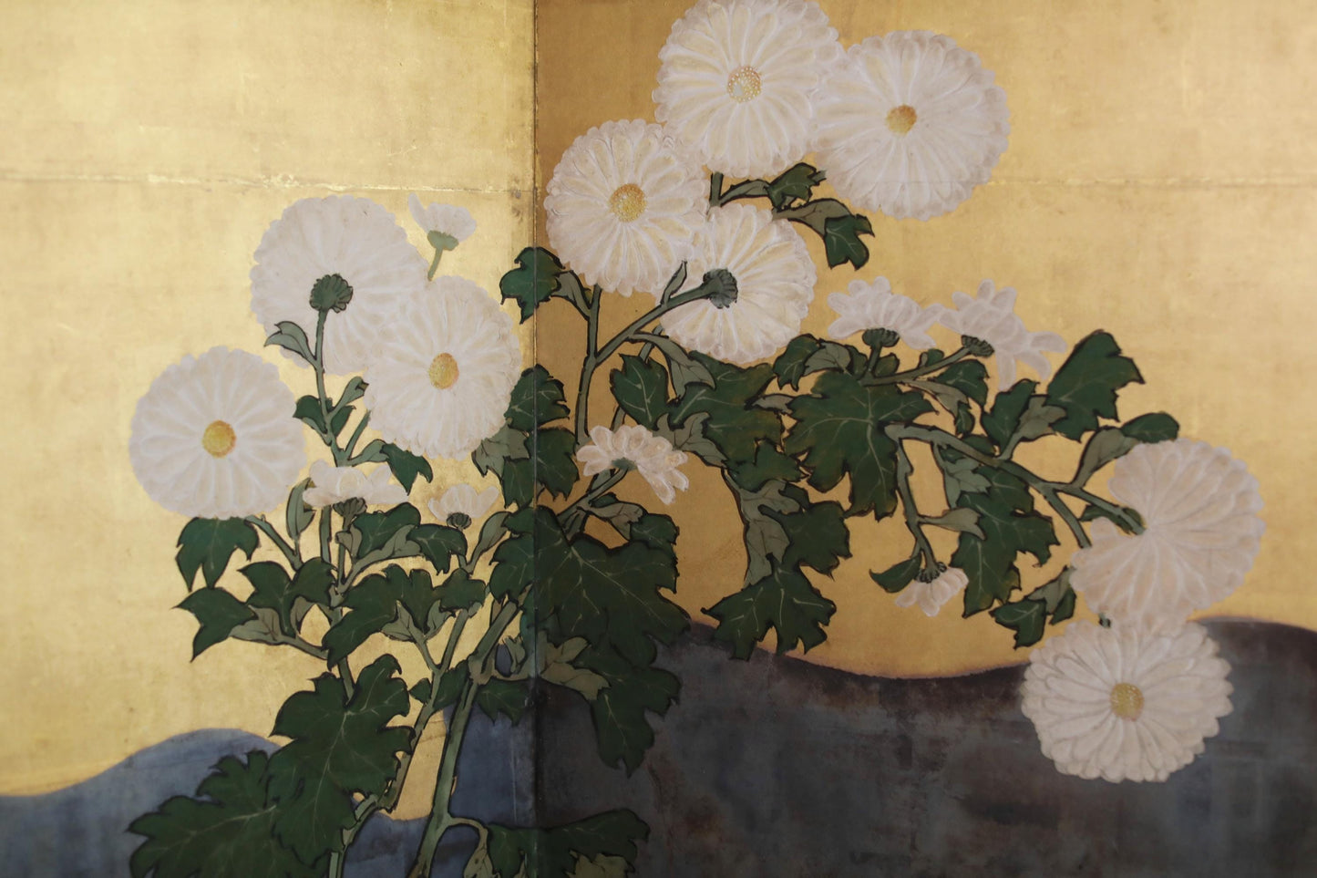 a close-up view of a cluster of white flowers with green leaves, arranged in a natural, organic manner.