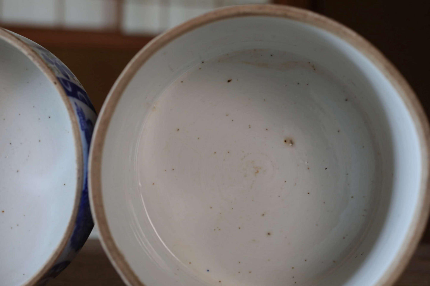 a close-up view of a white bowl with a blue rim, sitting on a table.