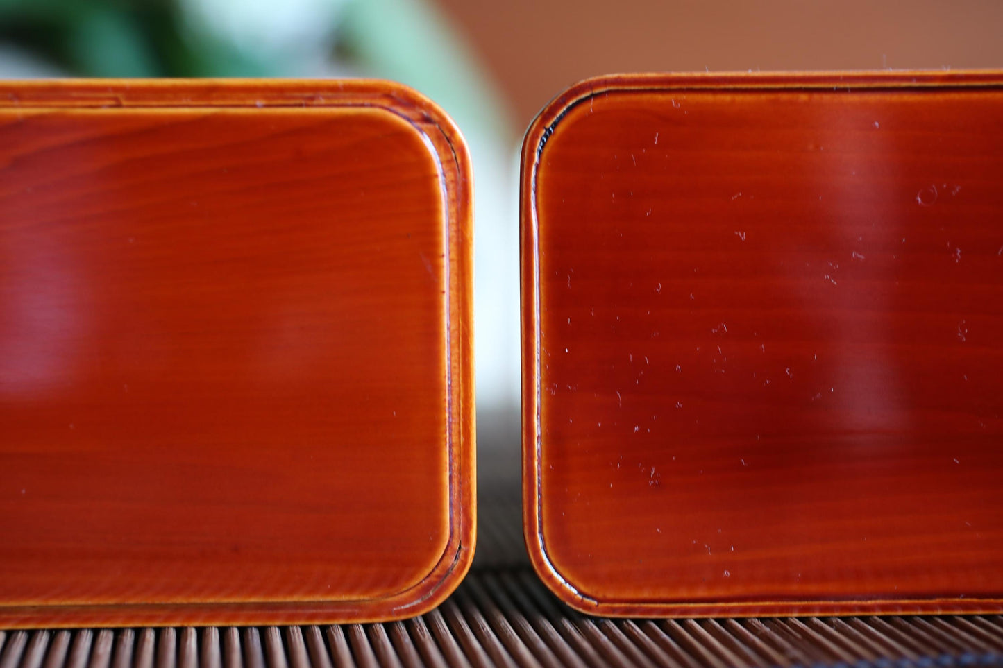 two identical red wooden boxes placed side by side on a surface.