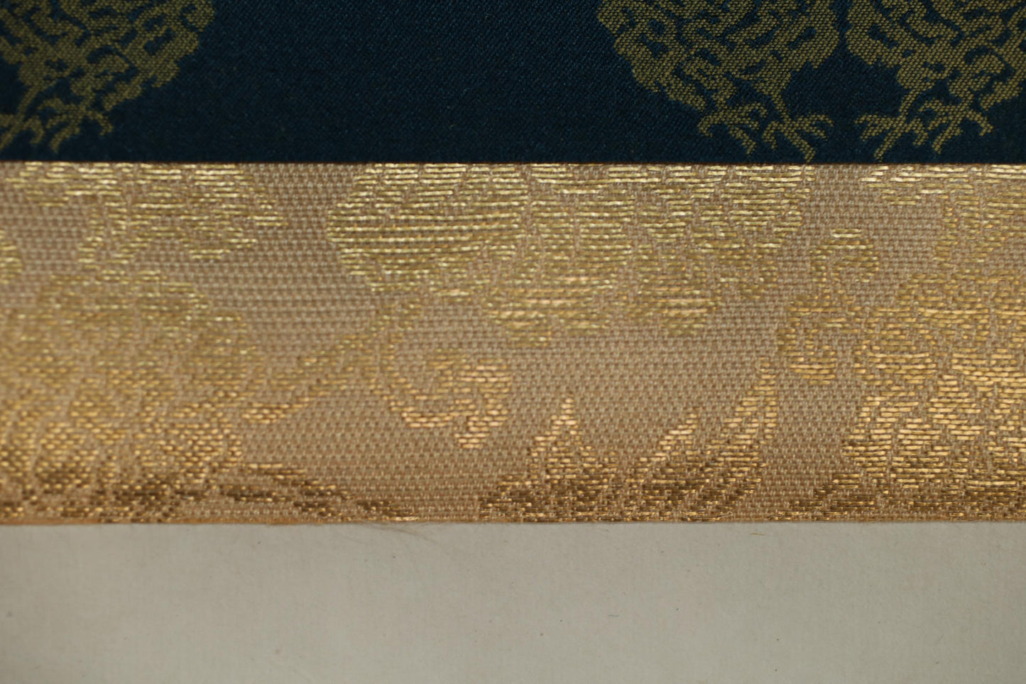 a close-up view of a fabric with a gold and black pattern, showcasing the intricate design and texture of the material.