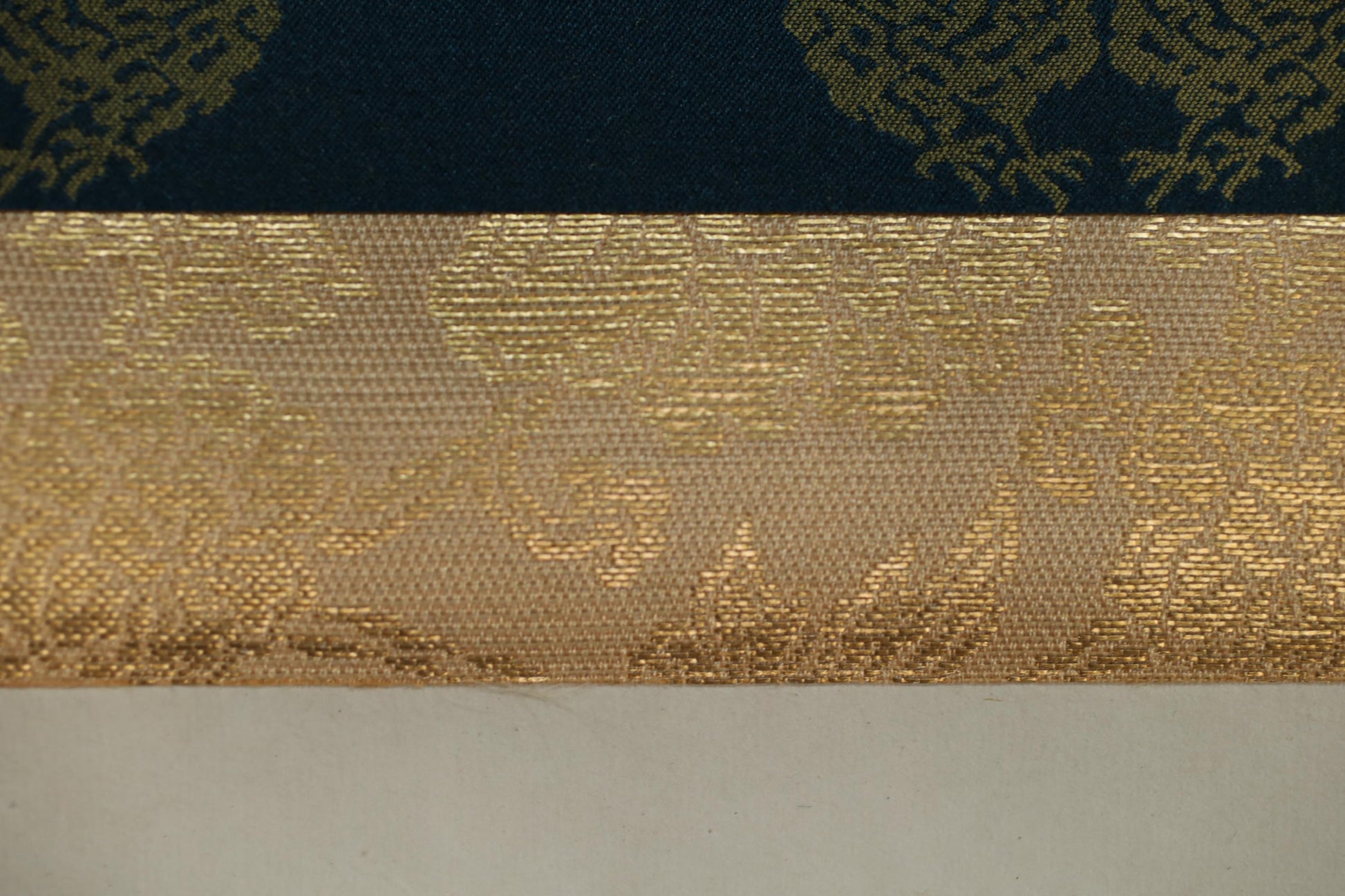 a close-up view of a fabric with a gold and black pattern, showcasing the intricate design and texture of the material.