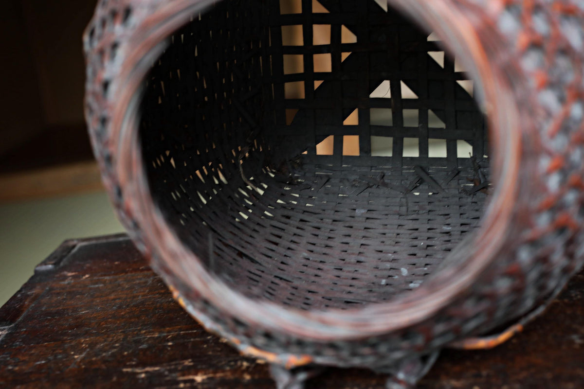a close-up view of a woven basket with a dark brown color and a textured pattern.