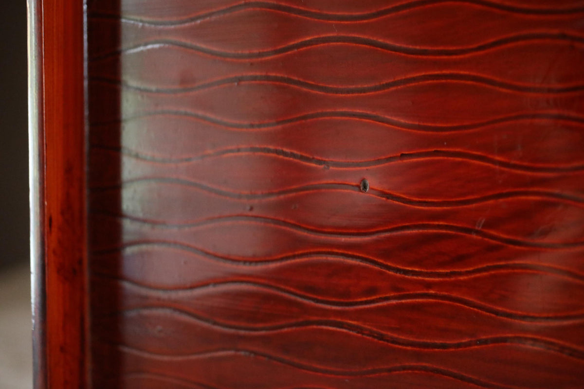 a close-up view of a wooden surface with a distinctive wavy pattern.