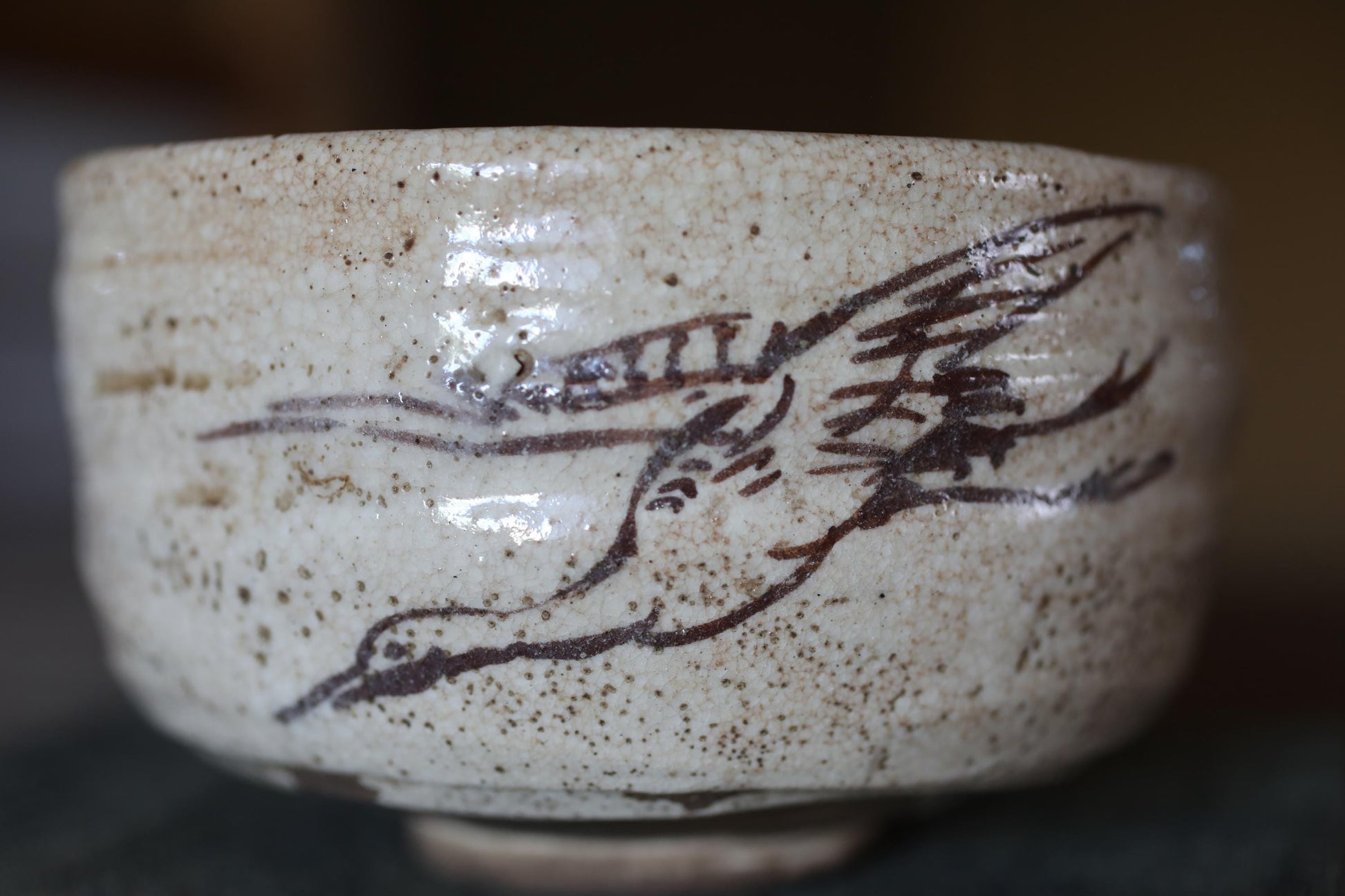 A close-up image of a ceramic bowl with a bird design on it.