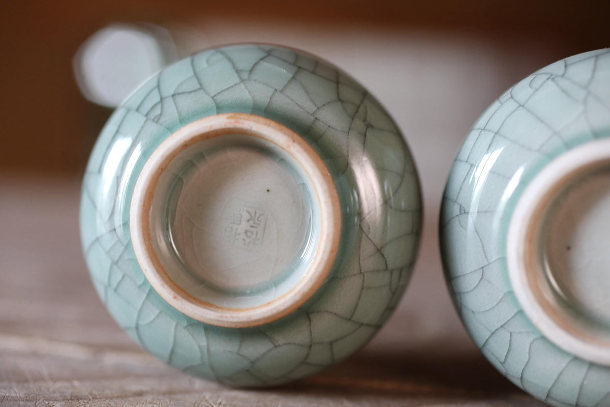 two ceramic bowls with a blue and white color scheme, placed on a wooden surface.