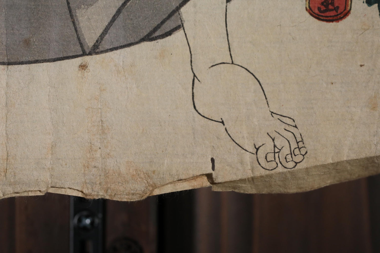 a close-up view of a piece of paper with a simple black line drawing of a hand.