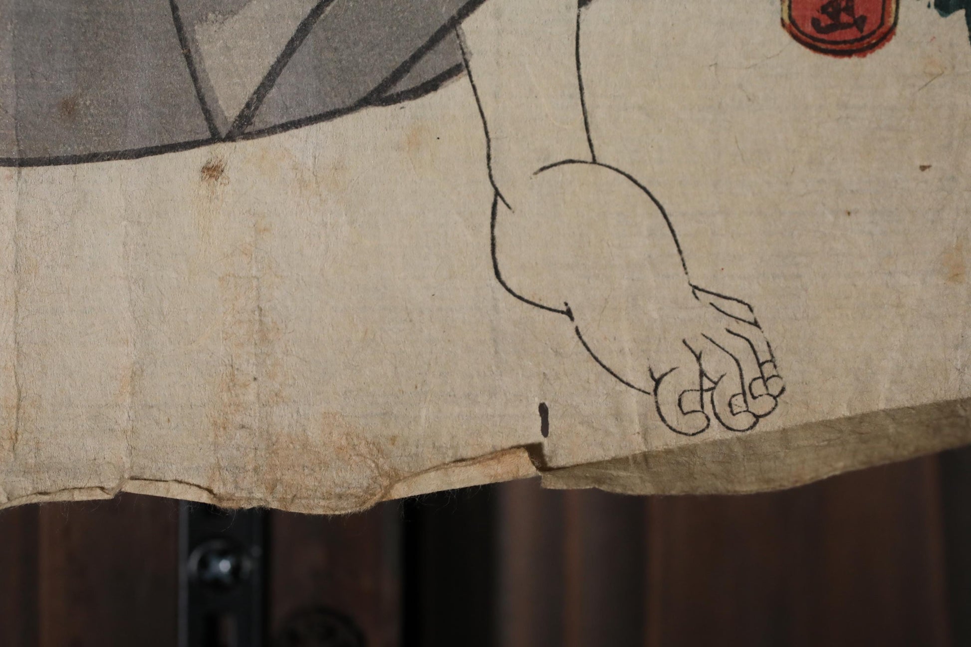 a close-up view of a piece of paper with a simple black line drawing of a hand.
