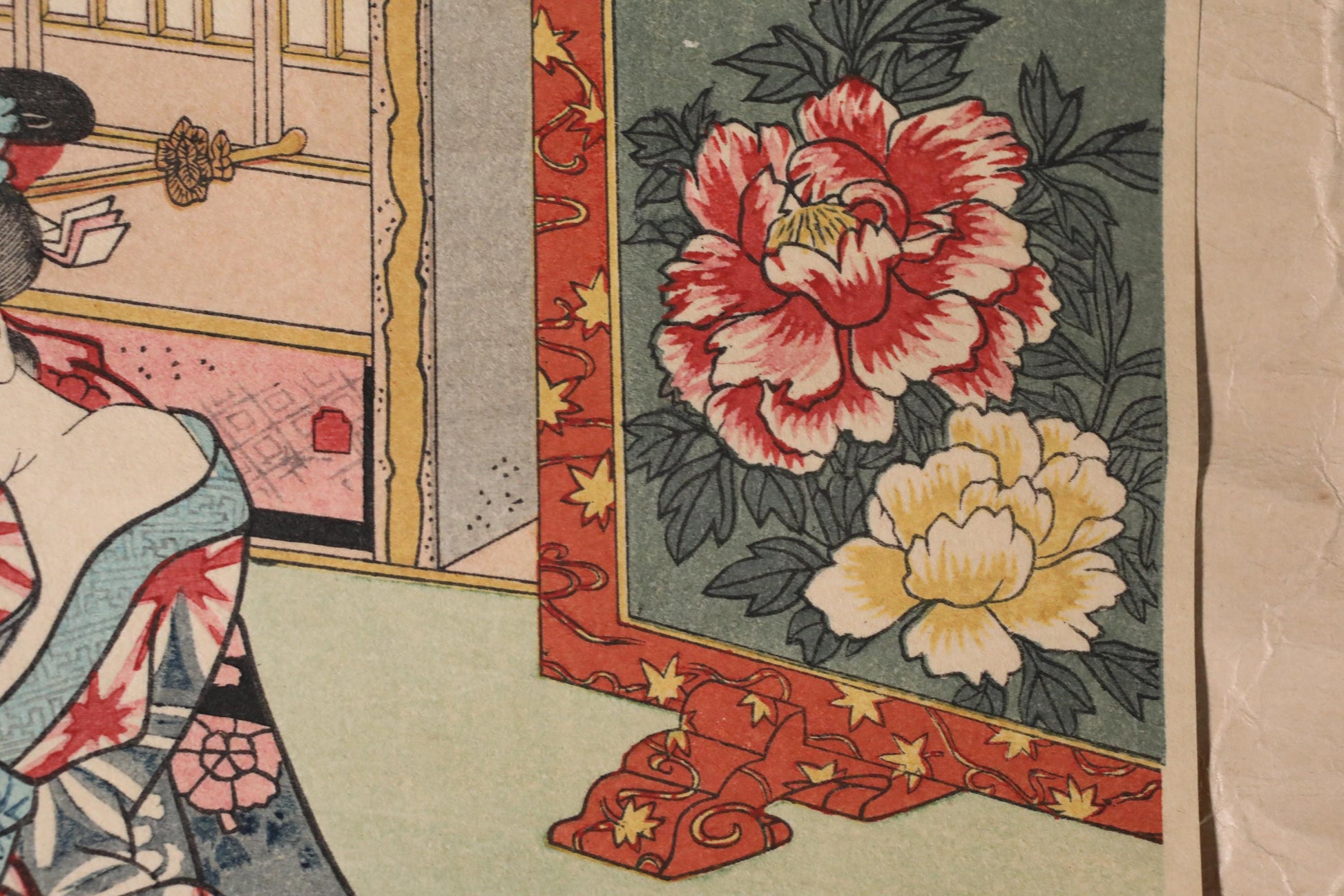 The image is a close-up of a colorful floral print, featuring a large red and white flower in the center. The background is a dark green color with a floral pattern.