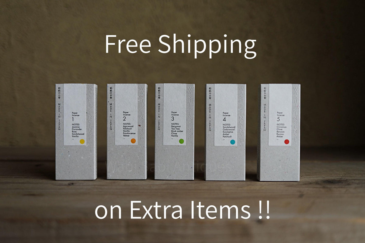 five boxes of different sizes, each with a label, arranged on a wooden surface. The boxes are white and have text on them, indicating that they are for free shipping on extra items.