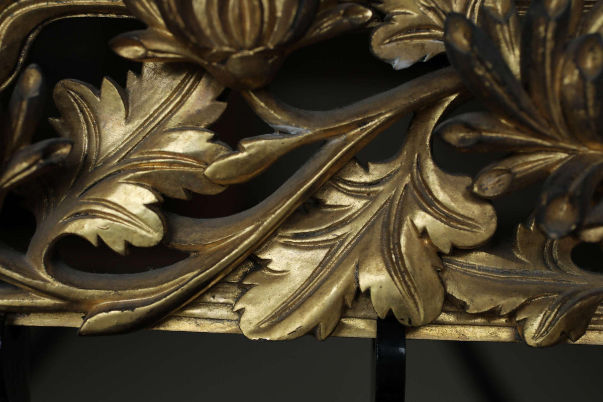 intricate golden leaf designs with a dark background.